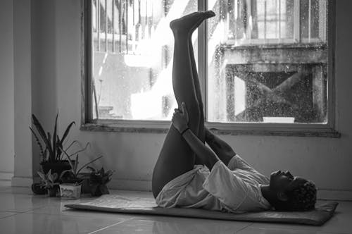 Free Monochrome Photo of a Woman Stretching Her Legs Stock Photo