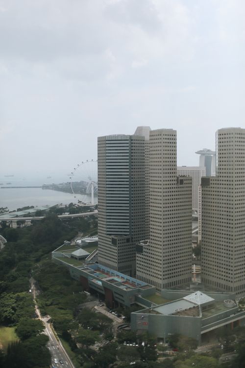 Free Aerial view of Singapore's urban landscape featuring high-rise buildings and Marina Bay Sands. Stock Photo
