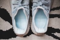 Comfy blue gumshoes on carpet at home