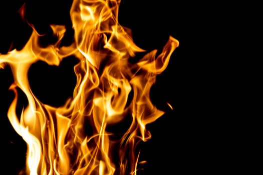 Captivating image of burning flames against a black backdrop, showcasing the dynamic nature of fire.