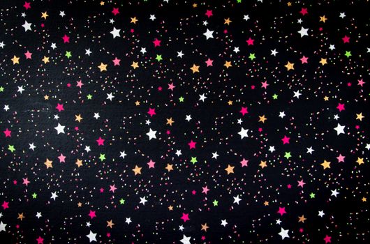 Vibrant star pattern with colorful dots against a black background, perfect for festive designs.