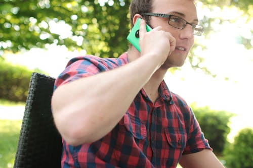 Free Man Placing His Phone on His Right Ear Stock Photo