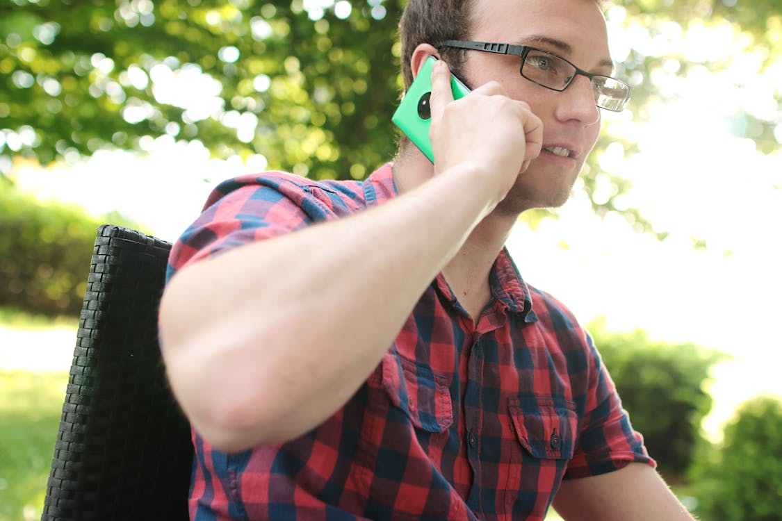 Man Placing His Phone on His Right Ear