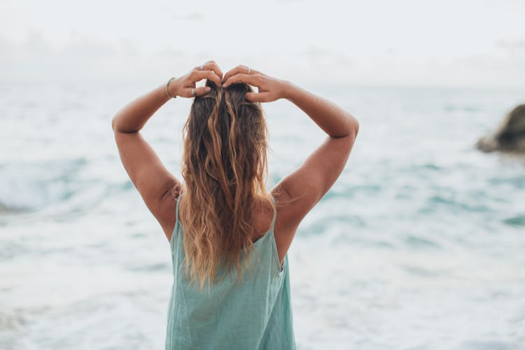 Anonymous Woman Enjoying Sea Breeze On Beach