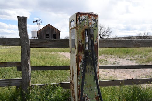 Free stock photo of barn, fence, gas pump