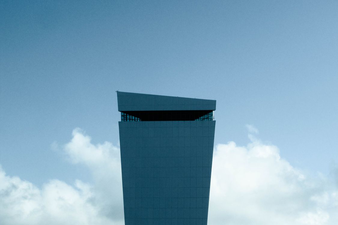 Blue Glass Walled High Rise Building Under Blue Sky · Free Stock Photo