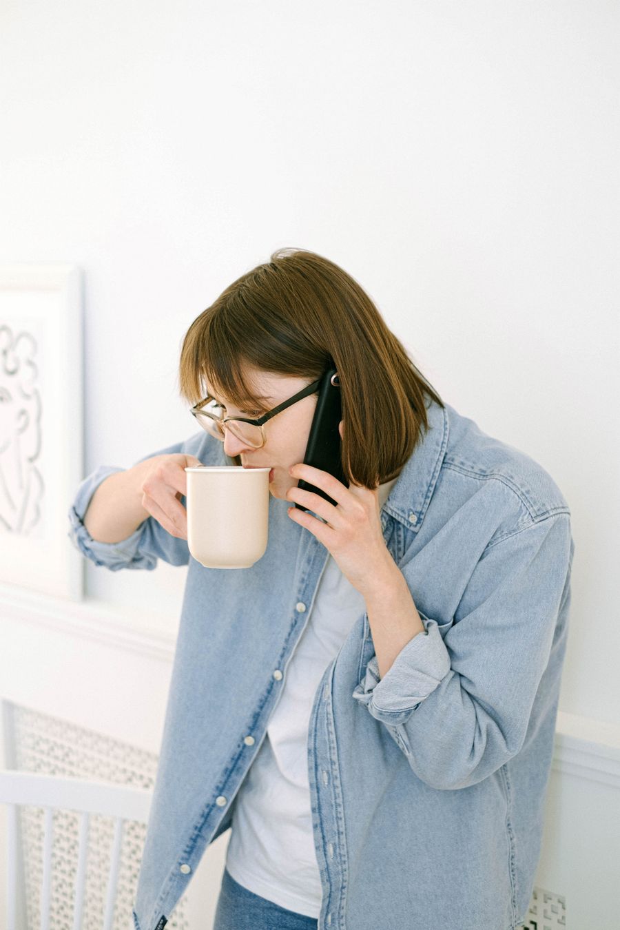 Homeowner calling a local service business from her kitchen