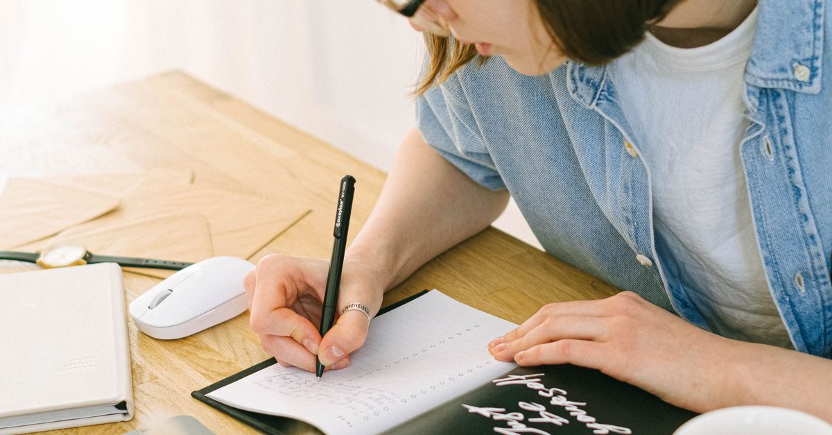 Woman Writing In Notebook Woman Writing in Notebook · Free Stock Photo