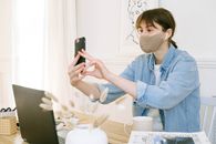 Woman in Face Mask Having Video Call
