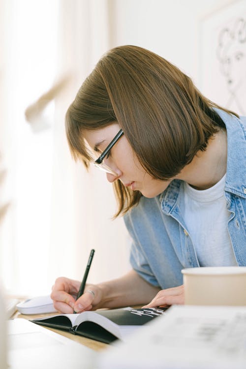 Close Up of Woman Taking Notes