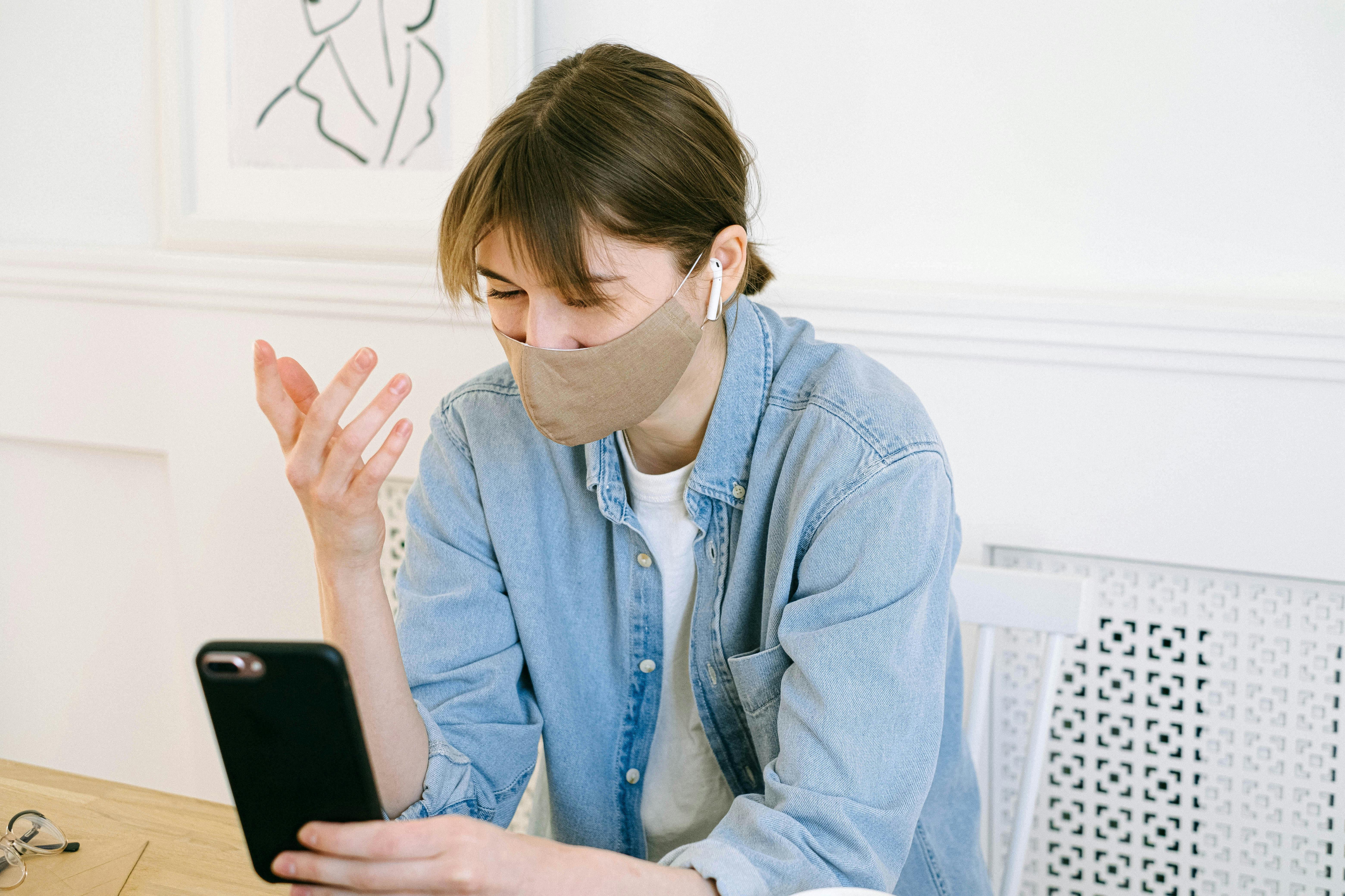 woman in face mask having video call