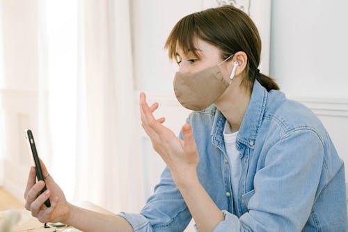 Woman With a Face Mask having a Video Call