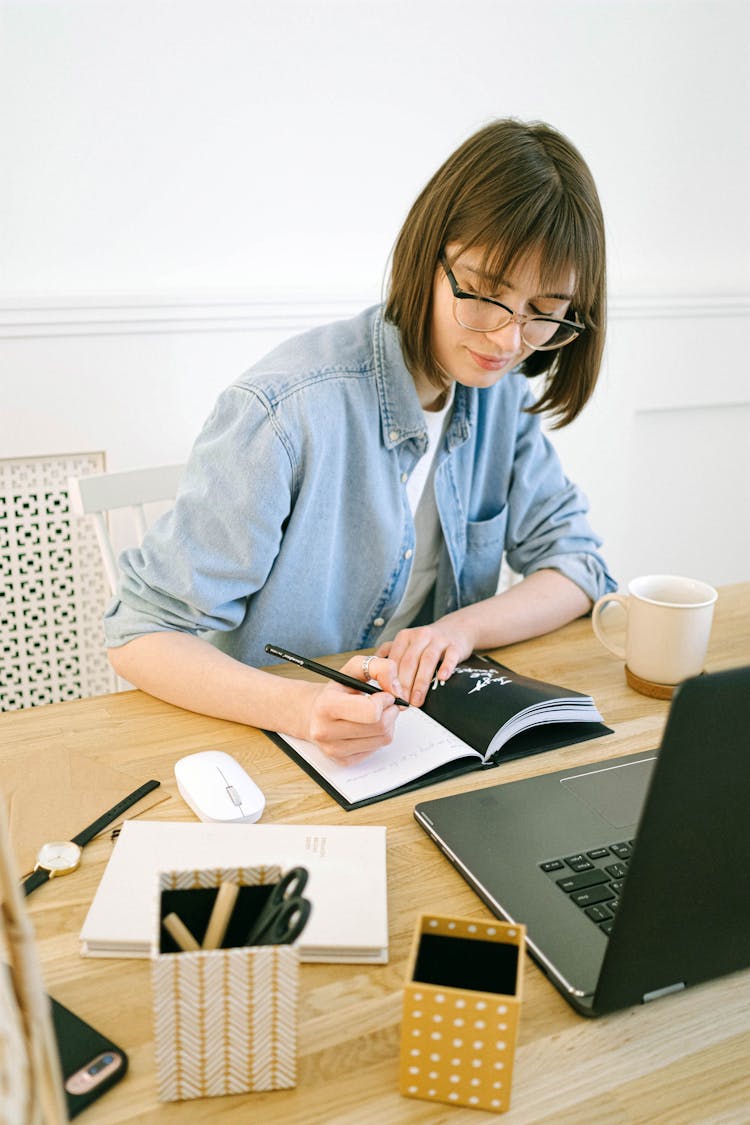 Woman Writing In Notebook