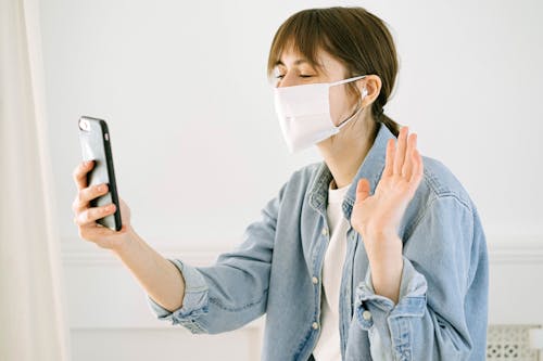 Free Woman in Face Mask Having Video Call Stock Photo