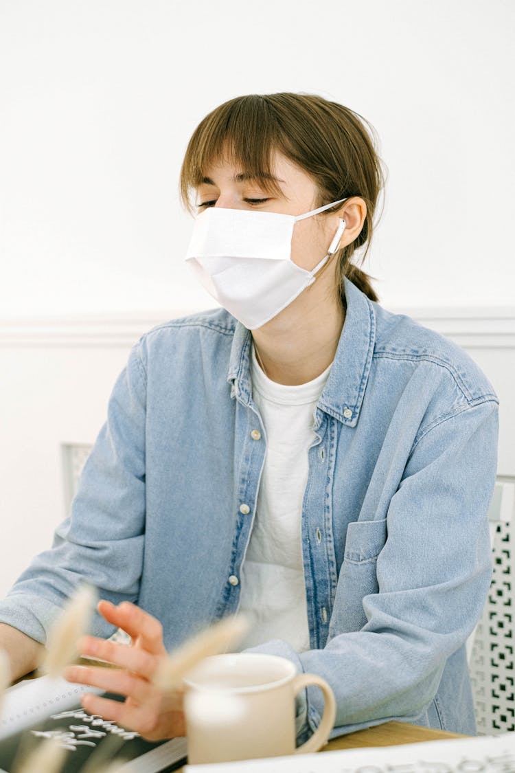 Woman In Face Mask Working At Home