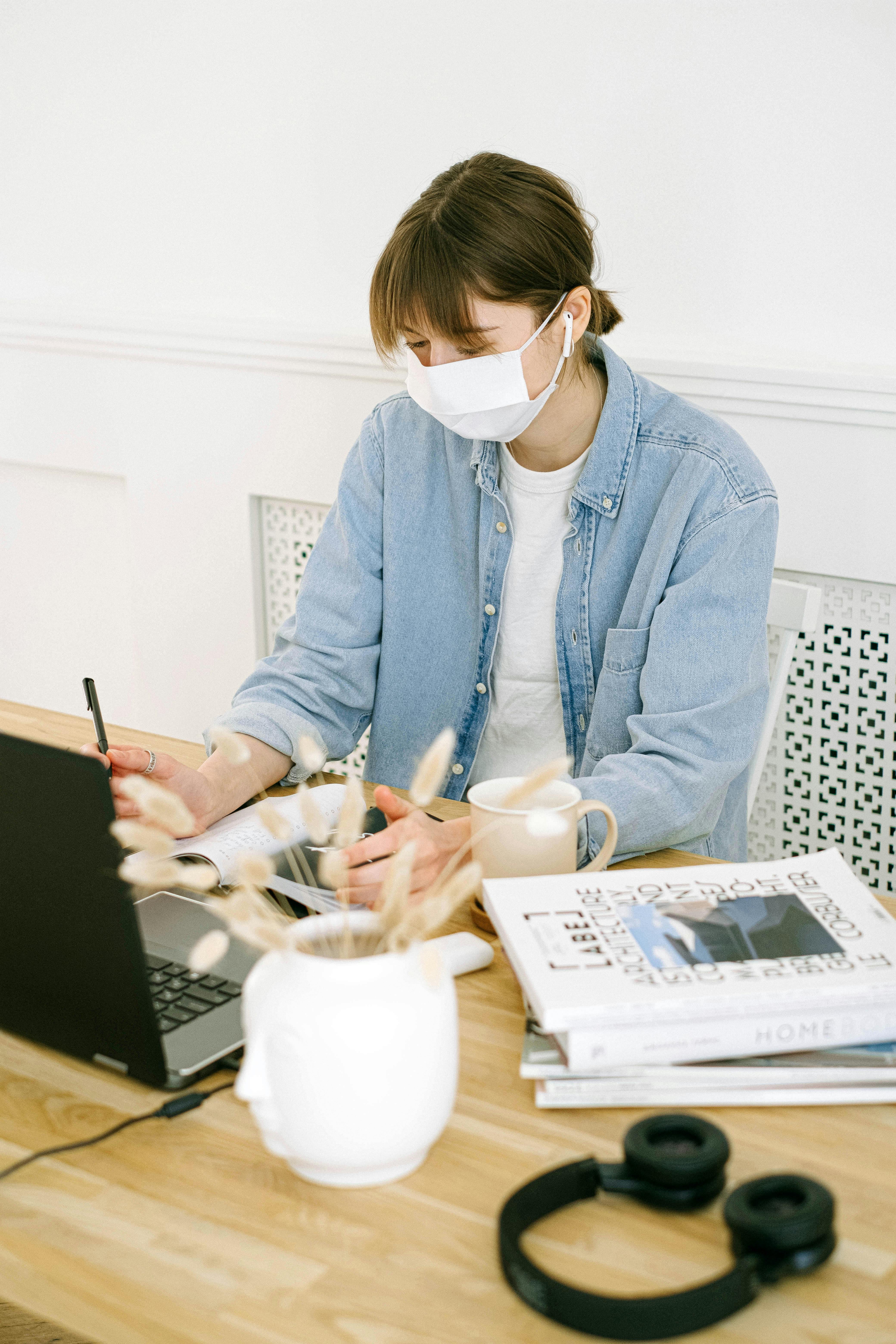 woman in face mask working at home