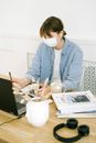 Woman in Face Mask Working at Home