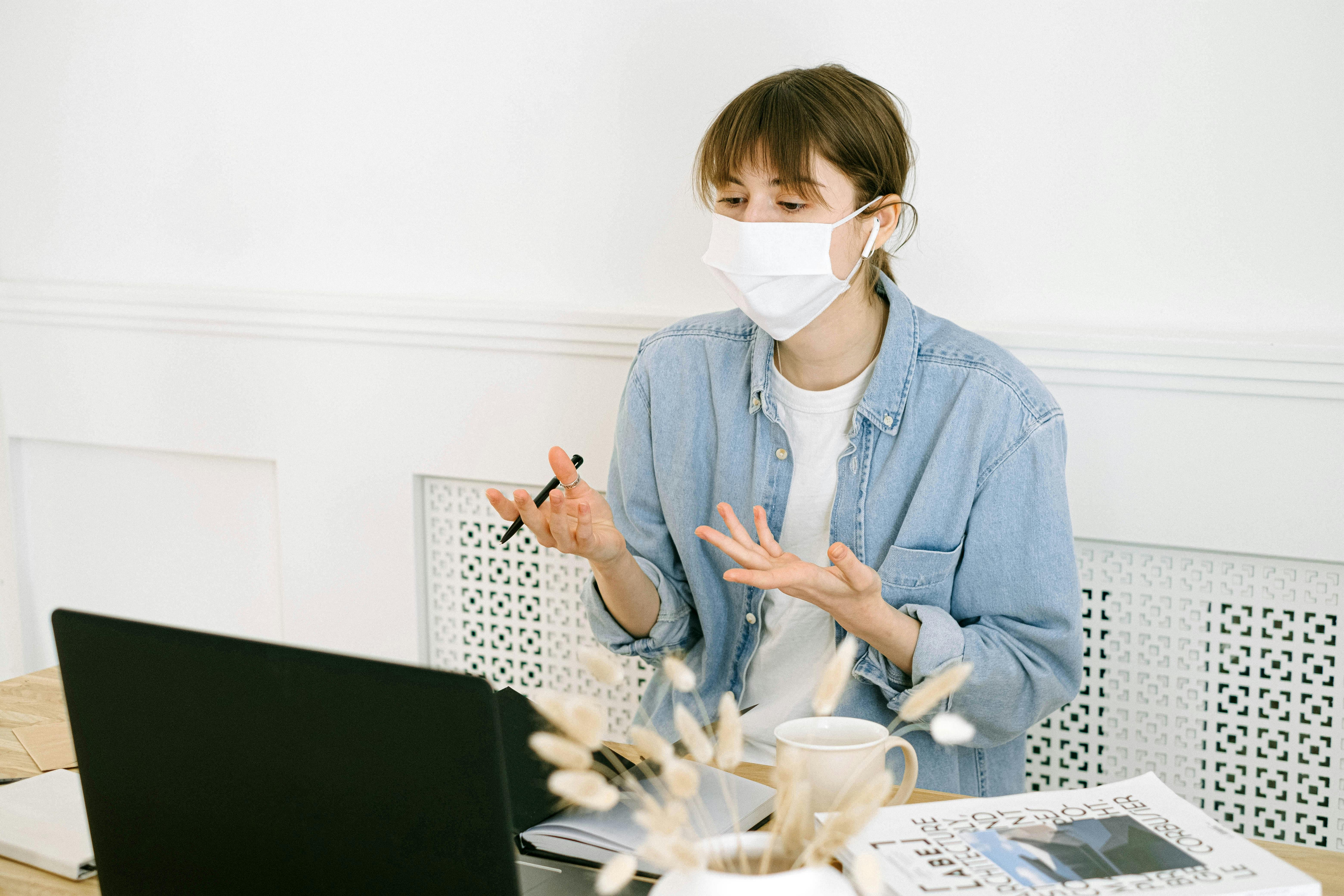 woman in face mask having video call