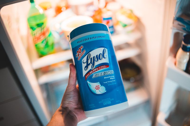 hand reaching toward a fridge shelf full of containers