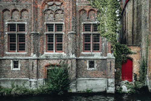 Free Fragment of exterior of ancient historic brick building with ornamental walls located on Steenhouwers Canal in Bruges Stock Photo