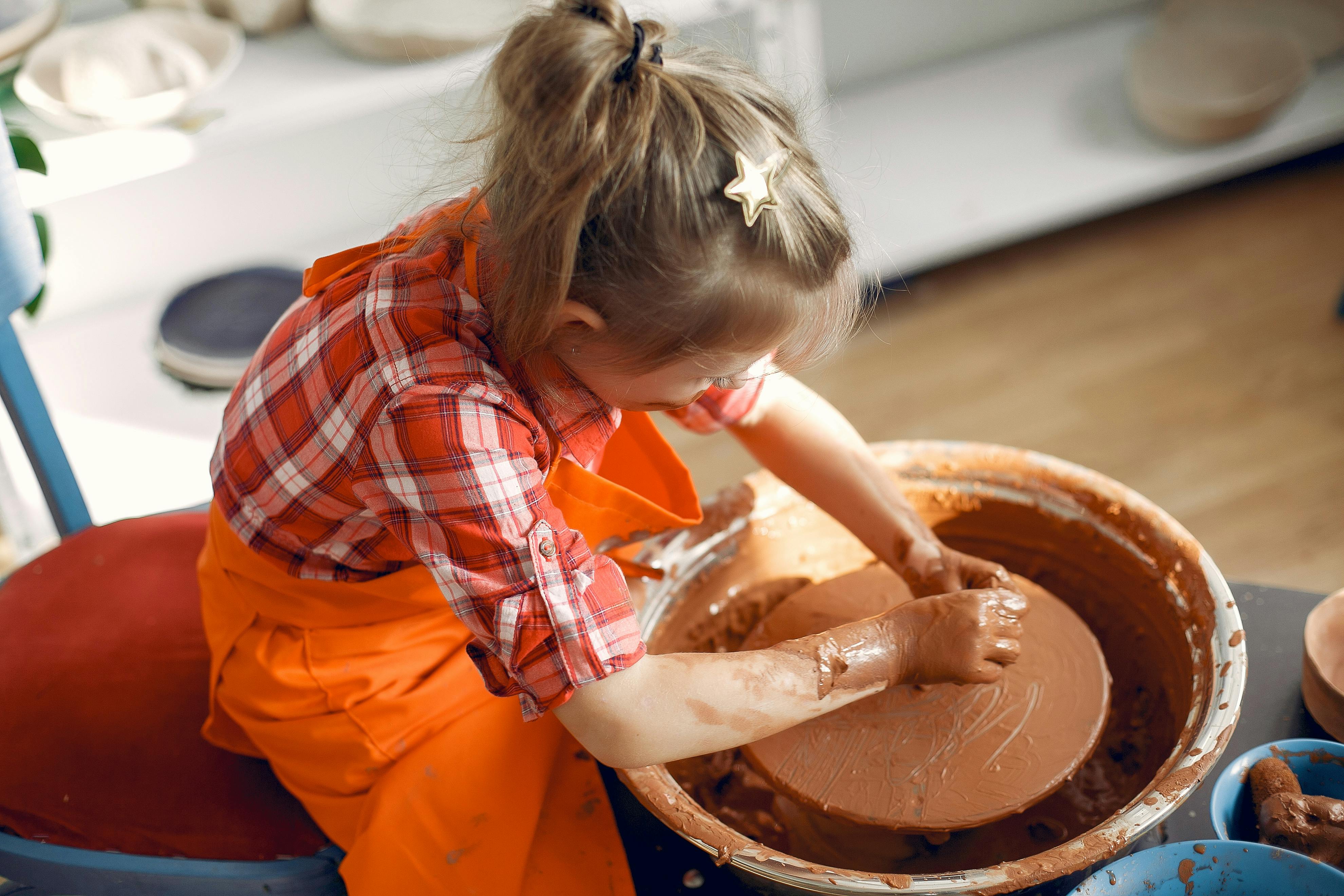 Little girl working on pottery wheel · Free Stock Photo