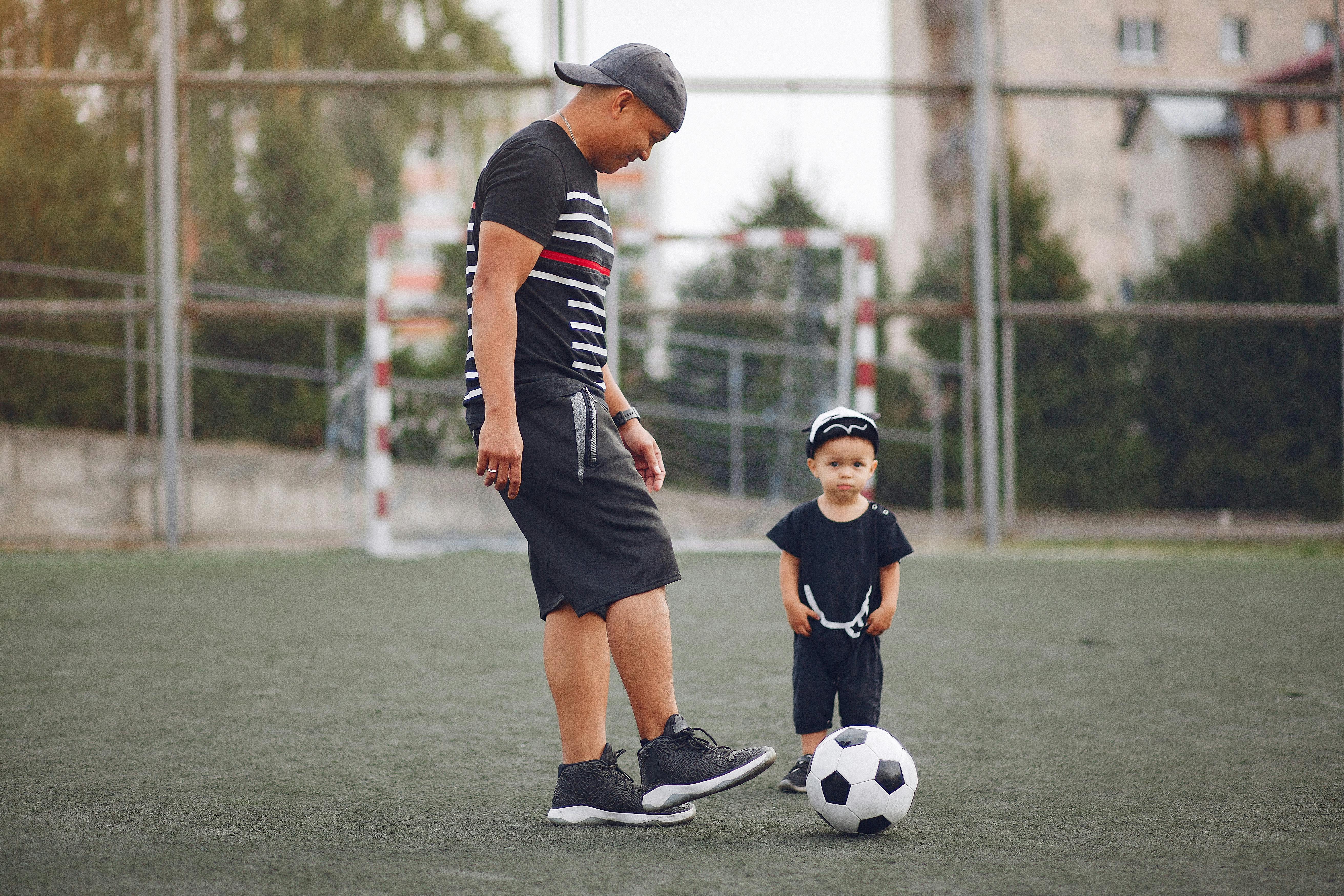 happy father and son playing with ball