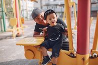 Father and cute son on playground