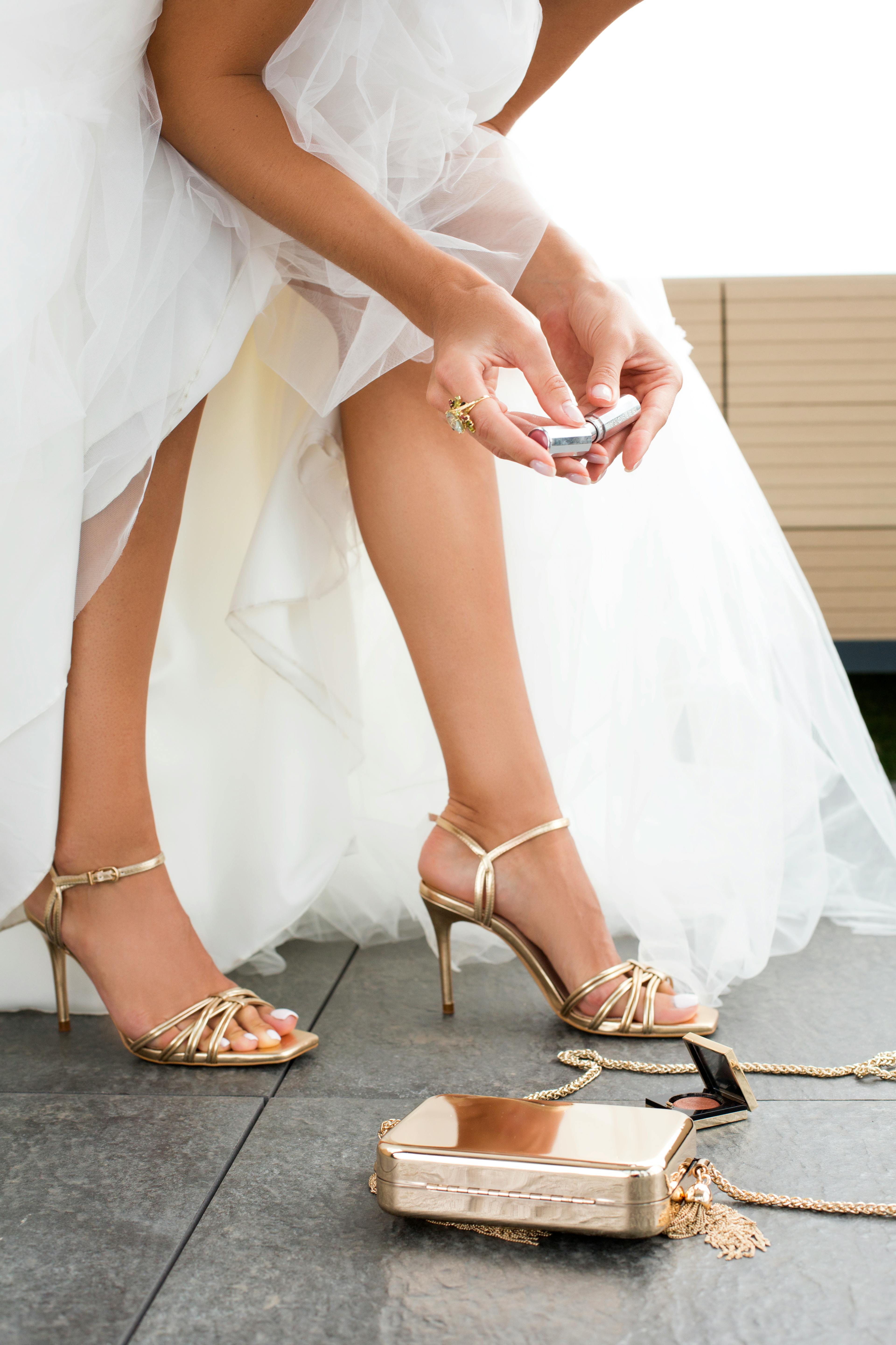 crop bride with makeup tools before wedding ceremony