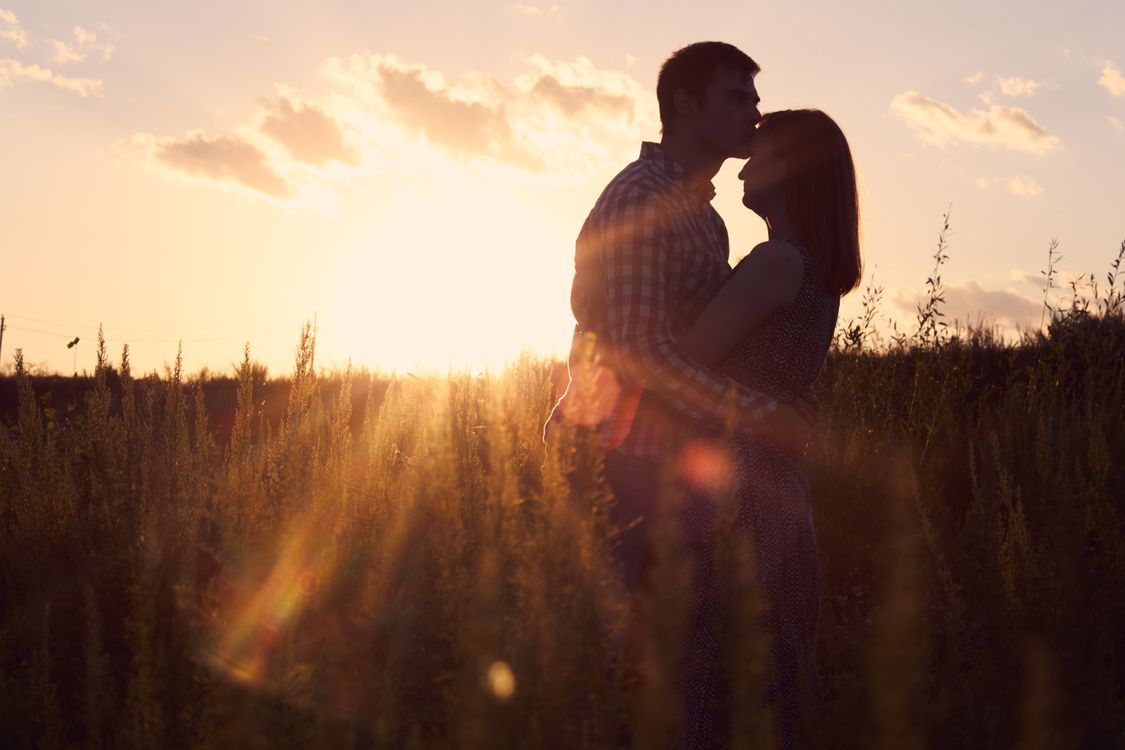 Couple Cuddle at Sunset · Free Stock Photo