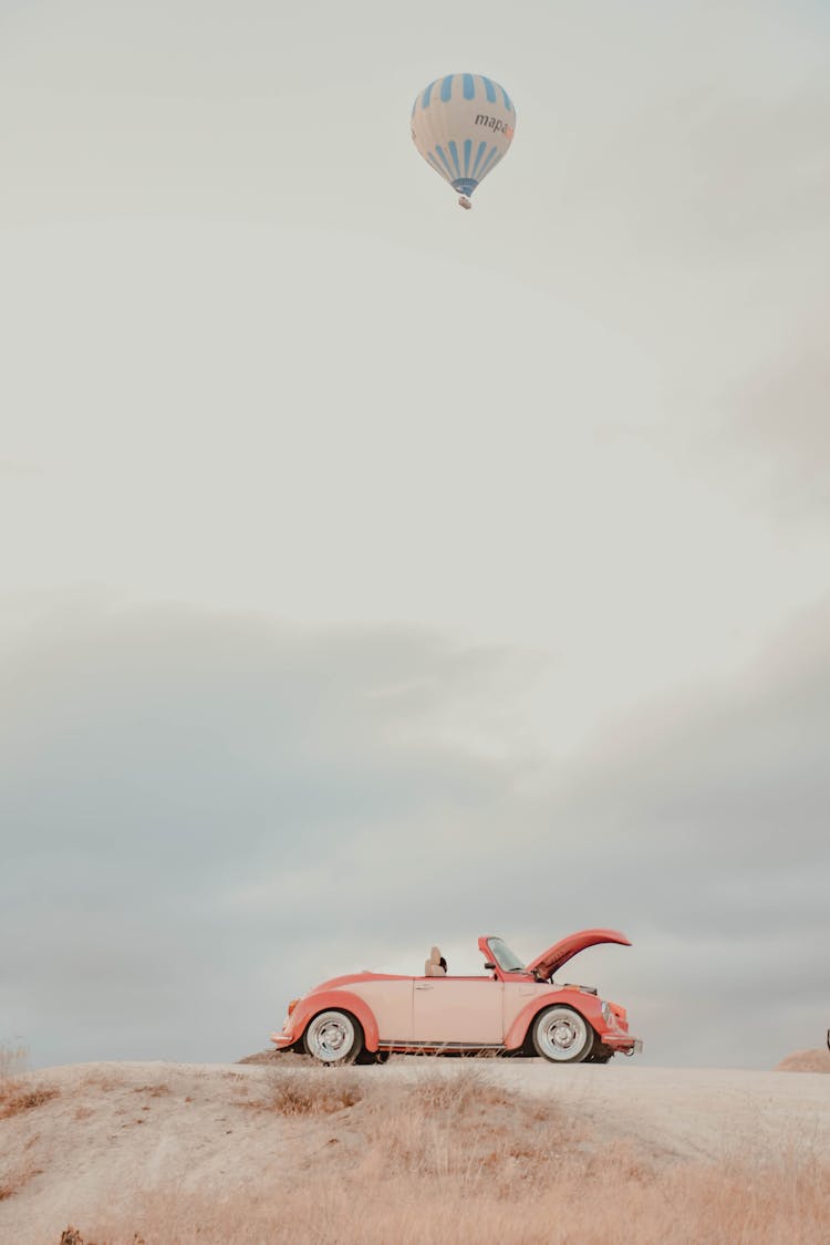 Air Balloon Flying Over Vintage Car