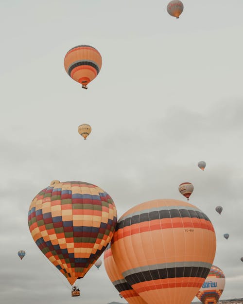 Colorful air balloons flying in overcast sky
