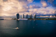 Island with modern skyscrapers against cloudy sky