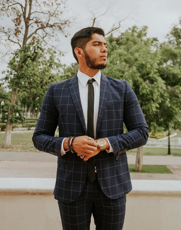 Confident Man In Plaid Suit Against Trees