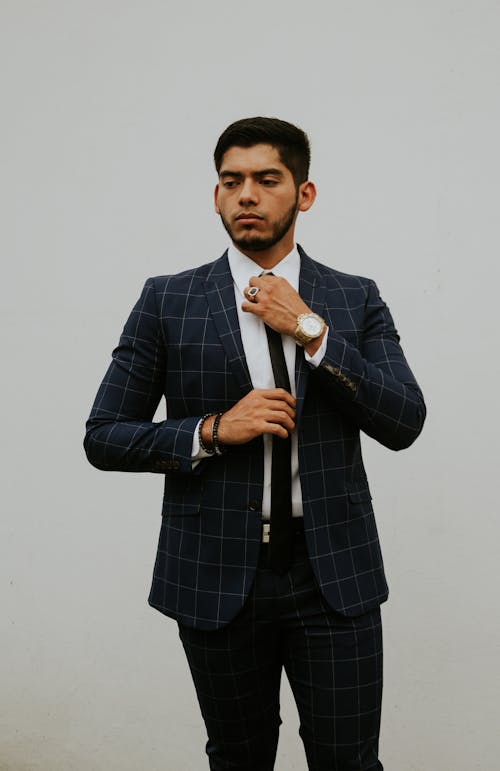 Confident male entrepreneur adjusting tie