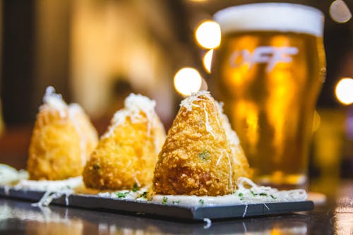 Fried Food on a Plate and a Glass of Beer