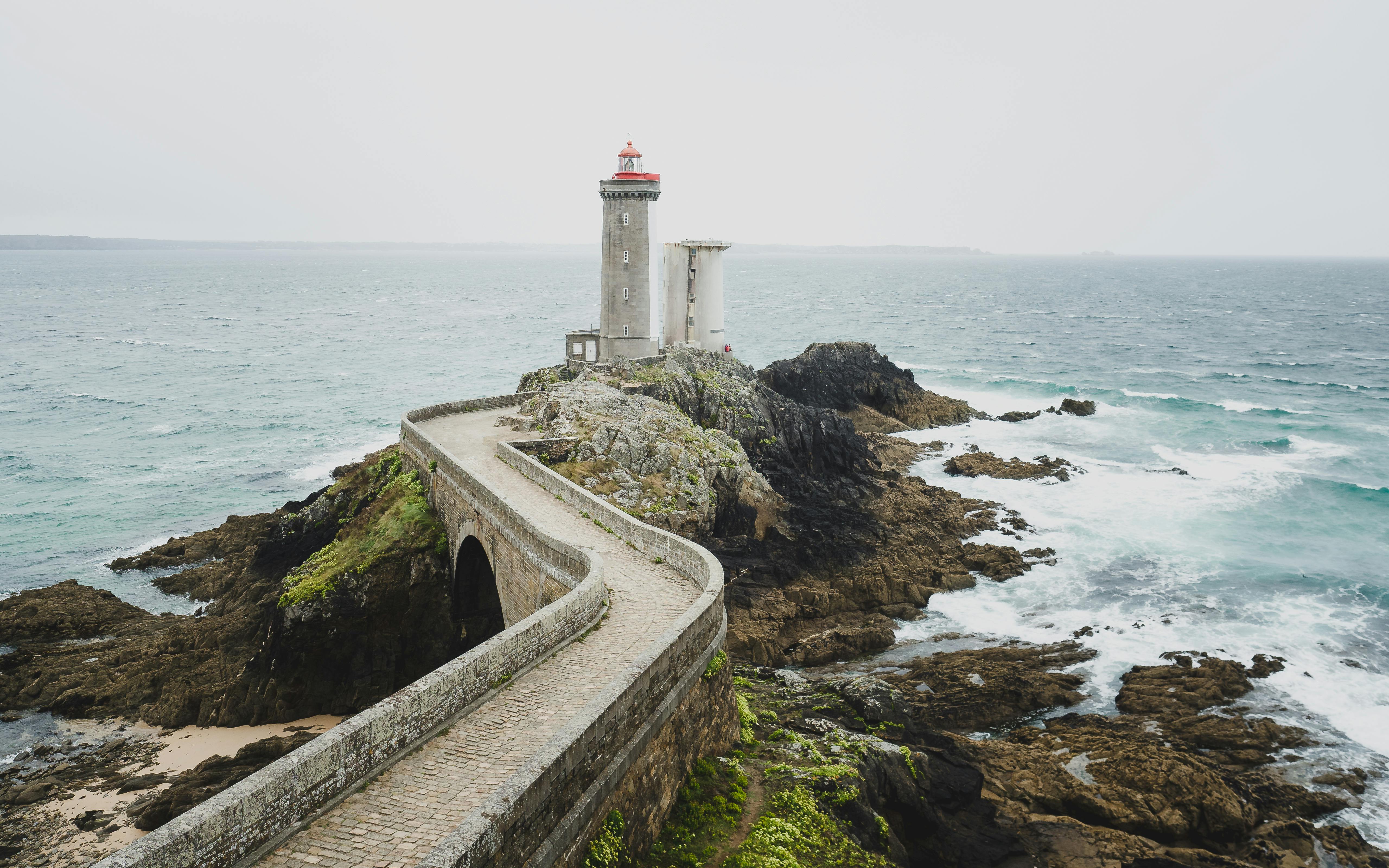 White Lighthouse On Brown Rocky Shore · Free Stock Photo