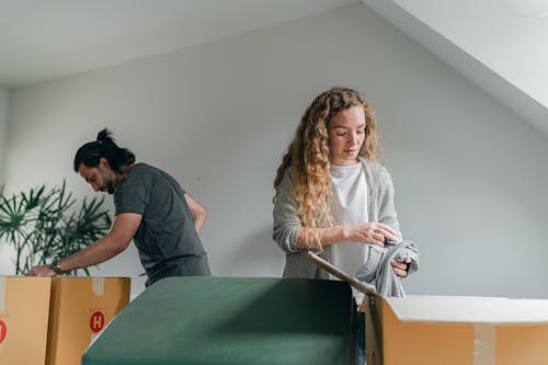 Free Concentrated couple packing boxes before renovation Stock Photo