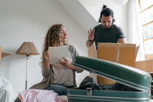 Free Focused couple packing stuff before moving out Stock Photo