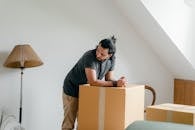 Ponder ethnic guy in smart watch leaned on box