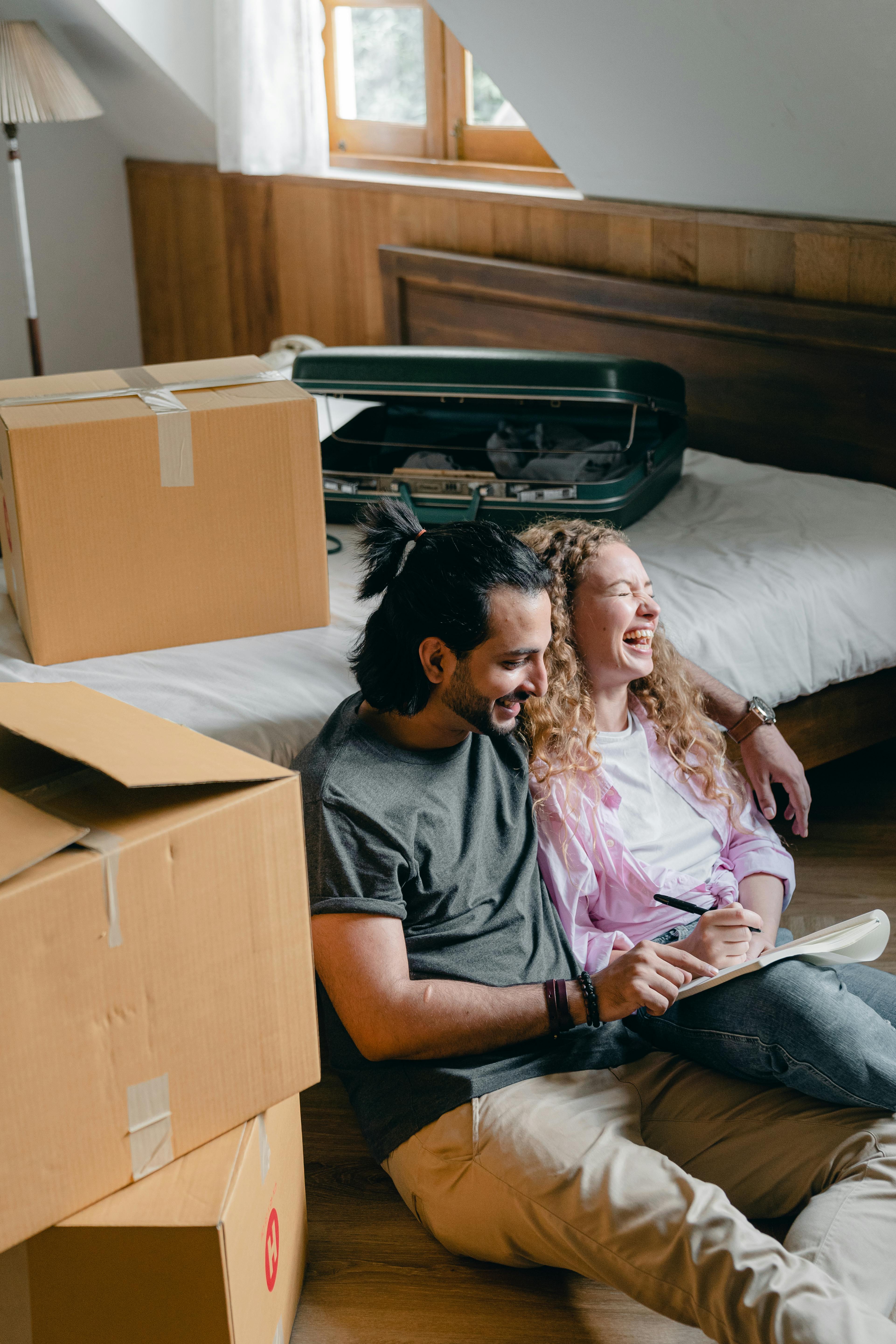 happy adult husband and wife moving in new home