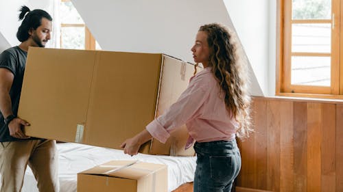 Free Focused diverse couple relocating in new house Stock Photo