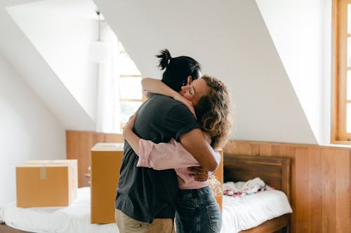 Free Happy couple hugging after moving in new apartment Stock Photo