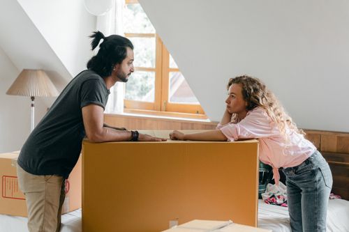 Couple unpacking boxes in their new home