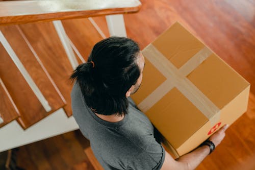 Man carrying box in new apartment