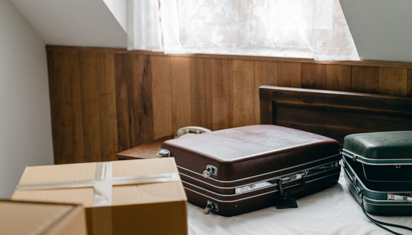 vacation training tips — Modern sports bag on bed in hotel room · Free. Photo: Pexels