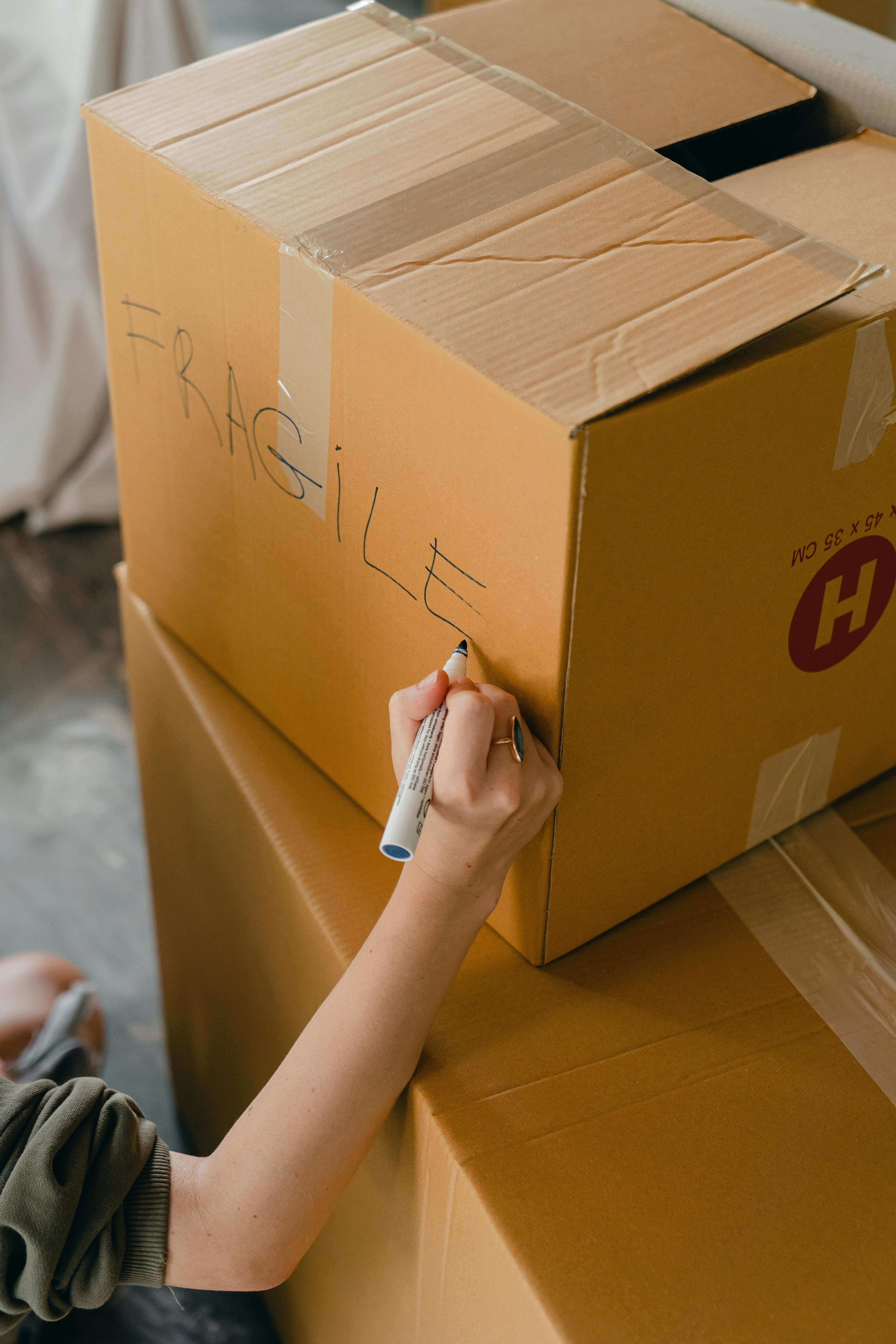 crop faceless woman sorting fragile carrying packages