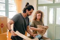 Focused young couple packing boxes together before moving in new house