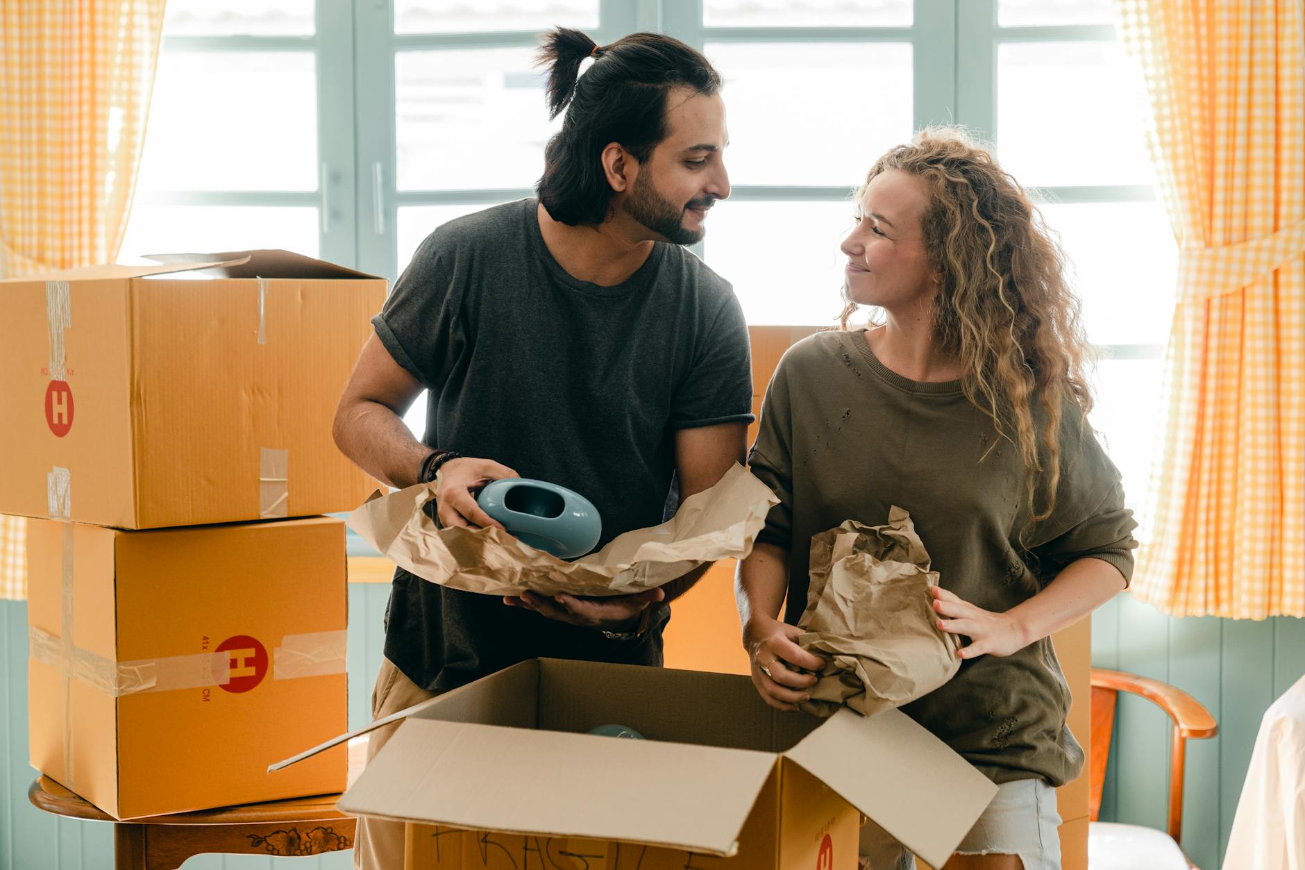 Multiethnic couple packing belongings