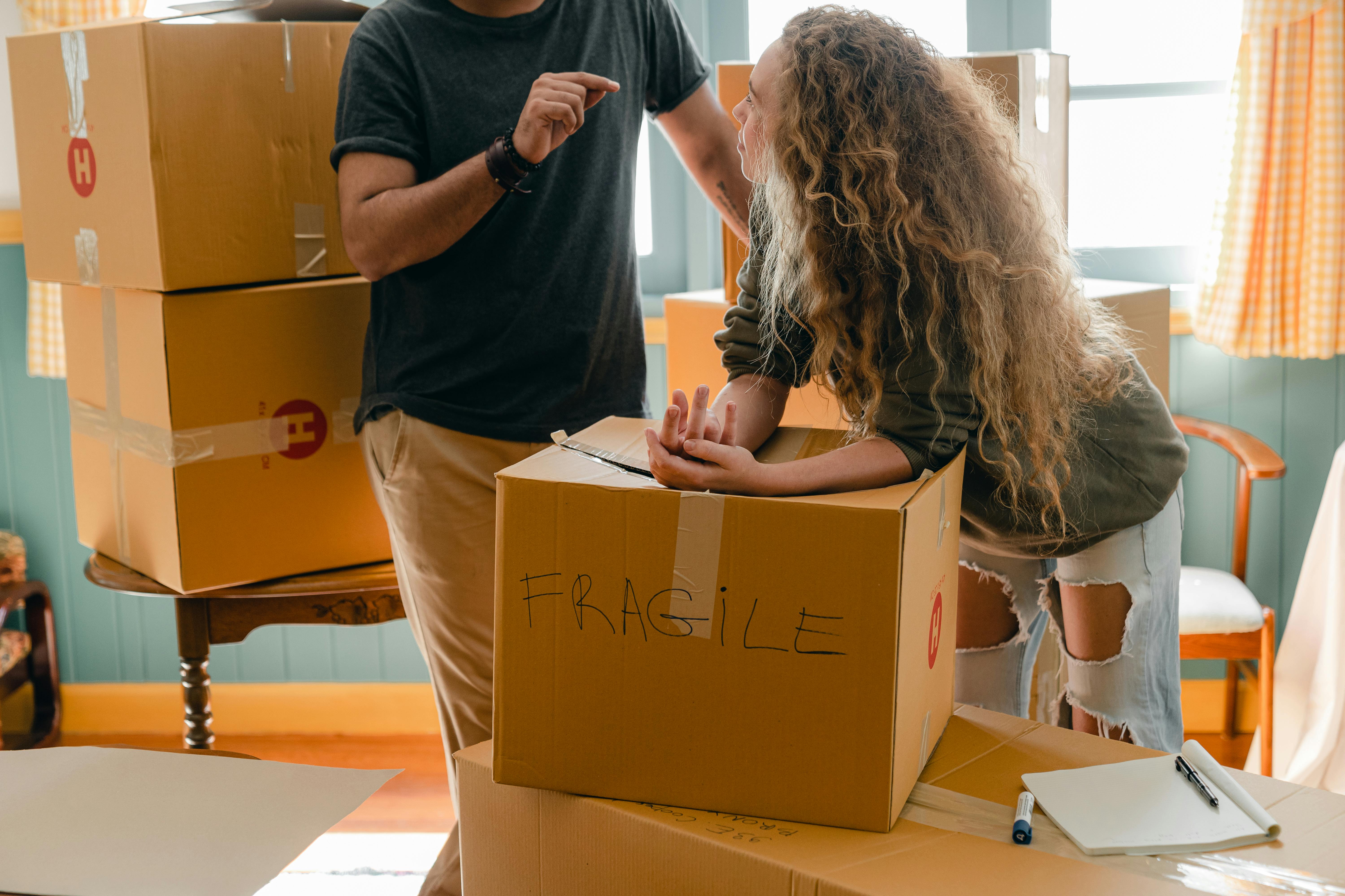 Woman and crop boyfriend near different boxes for moving · moving company in Aurora Co