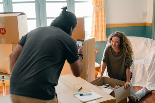 Boyfriend taking photo of cheerful girlfriend